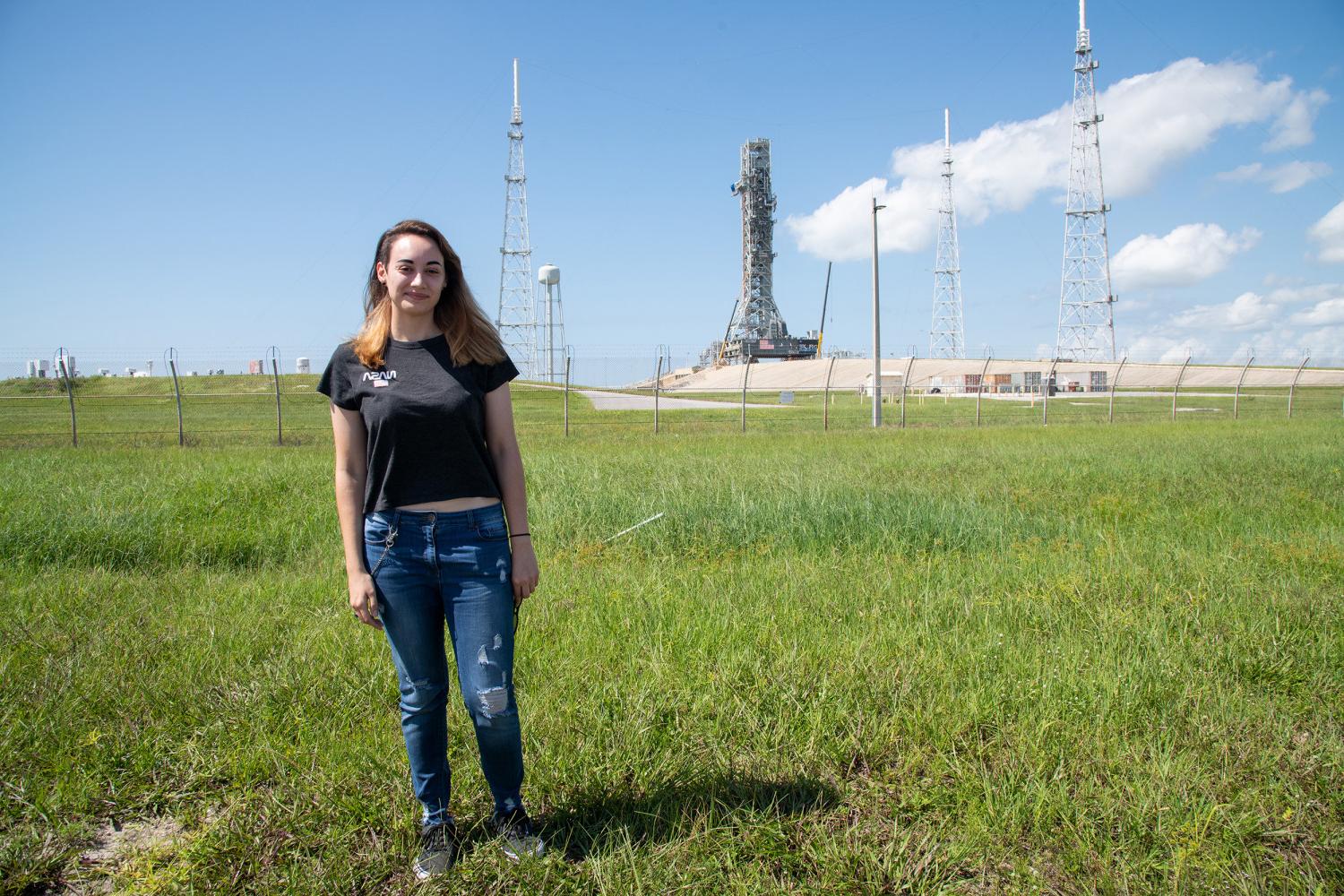 Carthage alumna, Taylor Peterson, in front of the LC-39 launch complex prior to the launch of NASA's Artemis I mission.